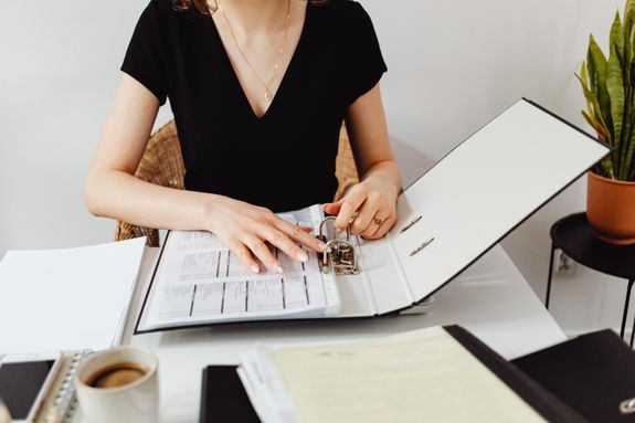 Woman organizing loan paperwork in a binder