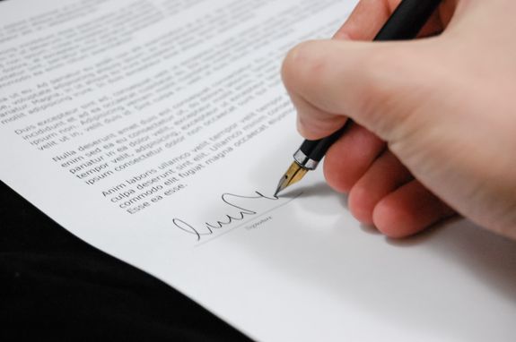 Person signing loan documents with a notary